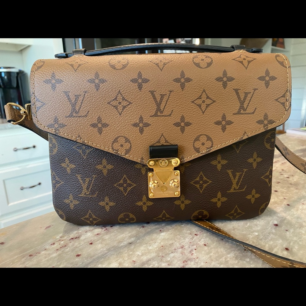 Louis Vuitton Pochette Metis in reverse monogram.